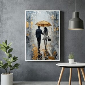 Abstract gold couple art with white frame on grey wall.